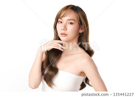 A beautiful young Asian woman with clean, fresh skin against a white background. Skincare, facial treatment, cosmetology, beauty, and spa. An elegant portrait of an Asian woman. A beautiful young Asian woman with clean, fresh skin against a white background. Skincare, facial treatment, cosmetology, beauty, and spa. An elegant portrait of an Asian woman. 135441227