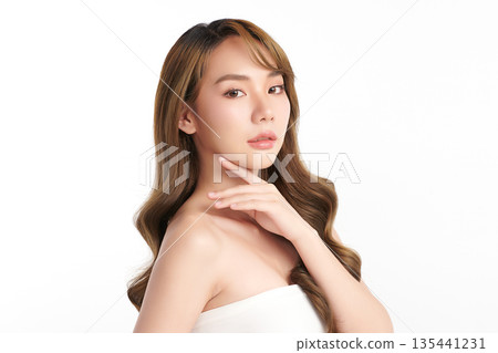 A beautiful young Asian woman with clean, fresh skin against a white background. Skincare, facial treatment, cosmetology, beauty, and spa. An elegant portrait of an Asian woman. A beautiful young Asian woman with clean, fresh skin against a white background. Skincare, facial treatment, cosmetology, beauty, and spa. An elegant portrait of an Asian woman. 135441231