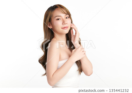 A beautiful young Asian woman with clean, fresh skin against a white background. Skincare, facial treatment, cosmetology, beauty, and spa. An elegant portrait of an Asian woman. A beautiful young Asian woman with clean, fresh skin against a white background. Skincare, facial treatment, cosmetology, beauty, and spa. An elegant portrait of an Asian woman. 135441232