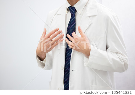 Close-up of a man in a white coat speaking using body language Close-up of a man in a white coat speaking using body language 135441821
