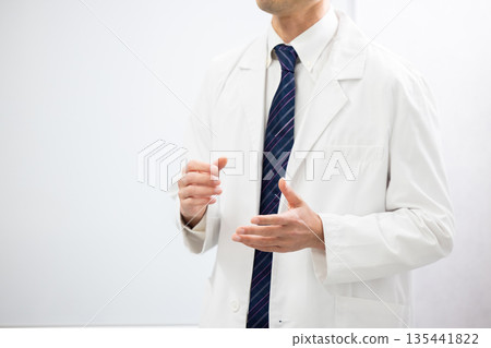 Close-up of a man in a white coat speaking using body language Close-up of a man in a white coat speaking using body language 135441822
