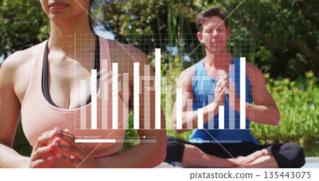 Meditating woman wearing peach sports bra using yoga mat in garden, with data overlay, copy space 135443075