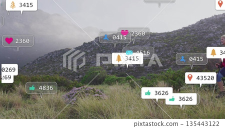 Hiking couple navigating hillside, with trekking poles daypacks social media icons, copy space 135443122