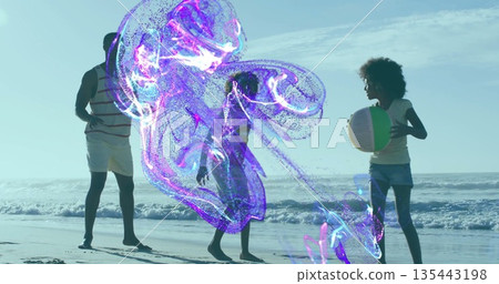 Walking family in swimwear carrying colorful beach ball along sandy beach, with purple-blue fluid 135443198