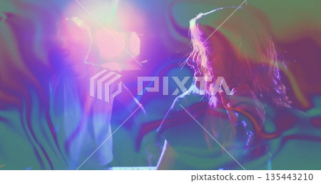 Performing female singer holding microphone near keyboard on stage, with swirling haze, copy space Performing female singer holding microphone near keyboard on stage, with swirling haze, copy space 135443210