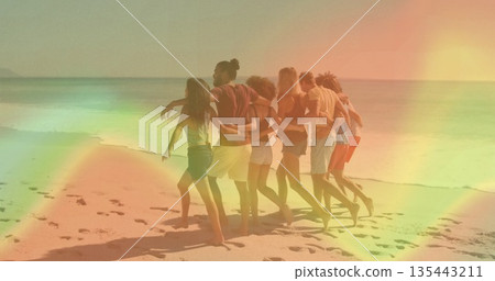 Walking group of seven friends in swimwear draping arms on sandy shoreline, vacation mood 135443211