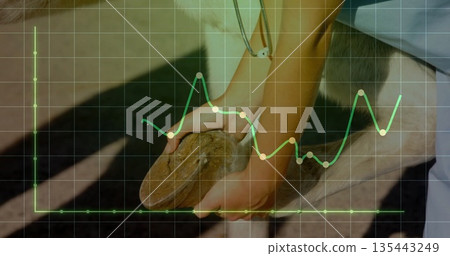 Holding carved wooden piece with female hand on workshop bench, earbud wire and data grid overlay 135443249