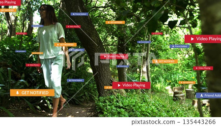 Walking barefoot woman wearing T-shirt on woodland path, floating notification labels, copy space 135443266