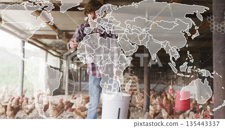 Farmer wearing plaid shirt feeding chickens in chicken coop, with bucket, digital world map overlay Farmer wearing plaid shirt feeding chickens in chicken coop, with bucket, digital world map overlay 135443337