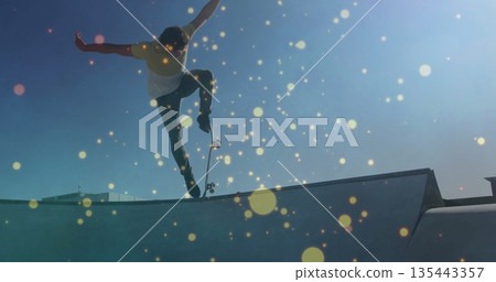 Launching male skateboarder performing trick on concrete bowl ramp coping at skate park, with bokeh 135443357