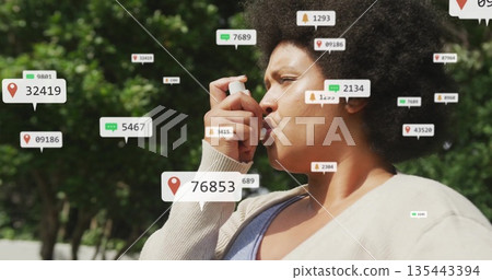 Holding asthma inhaler middle aged woman breathing outdoors in park with floating digital icons Holding asthma inhaler middle aged woman breathing outdoors in park with floating digital icons 135443394