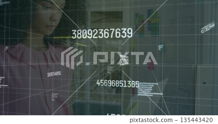 Woman in pink blouse analyzing floating numeric codes on glass board at office, planning wall 135443420