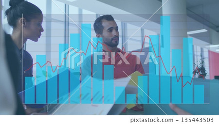 Two colleagues wearing business attire analyzing graph overlay in office, with laptop and folders Two colleagues wearing business attire analyzing graph overlay in office, with laptop and folders 135443503