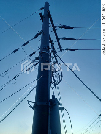 Telephone pole looking up against the blue sky Telephone pole looking up against the blue sky 135443628