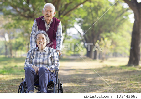 Asian senior or elderly old lady woman patient on wheelchair in park 135443663