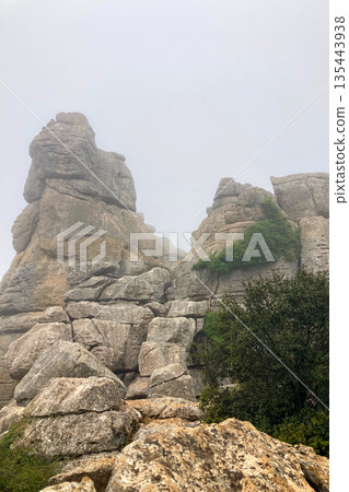A mystical morning walk through the rocky landscapes of Torcal de Antequera in Andalusia, Spain, as soft mist drifts under the gentle rays of the sun. A mystical morning walk through the rocky landscapes of Torcal de Antequera in Andalusia, Spain, as soft mist drifts under the gentle rays of the sun. 135443938