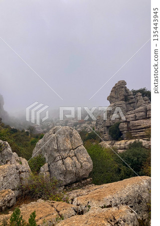A mystical morning walk through the rocky landscapes of Torcal de Antequera in Andalusia, Spain, as soft mist drifts under the gentle rays of the sun. A mystical morning walk through the rocky landscapes of Torcal de Antequera in Andalusia, Spain, as soft mist drifts under the gentle rays of the sun. 135443945