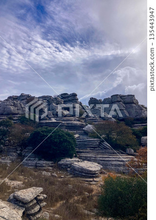 A mystical morning walk through the rocky landscapes of Torcal de Antequera in Andalusia, Spain, as soft mist drifts under the gentle rays of the sun. A mystical morning walk through the rocky landscapes of Torcal de Antequera in Andalusia, Spain, as soft mist drifts under the gentle rays of the sun. 135443947