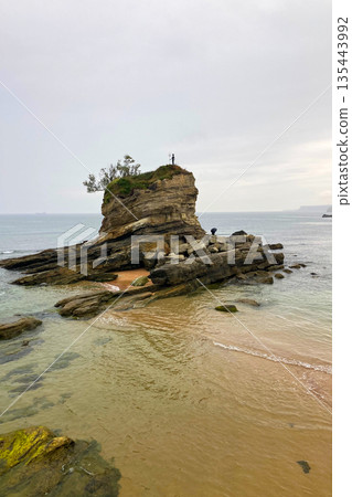 Wonderful view of the calm sea from the promenade in Santander, Spain, with soft waves and a peaceful coastal atmosphere. 135443992