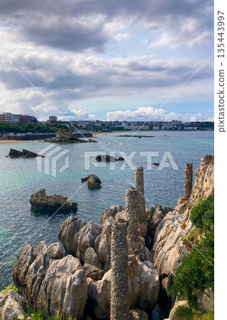Wonderful view of the calm sea from the promenade in Santander, Spain, with soft waves and a peaceful coastal atmosphere. Wonderful view of the calm sea from the promenade in Santander, Spain, with soft waves and a peaceful coastal atmosphere. 135443997