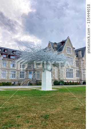 Magdalena Palace and Park in Santander, Spain, with its elegant architecture surrounded by lush green gardens and coastal views. 135444018