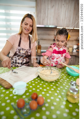Baking memories together in a cozy kitchen on a sunny afternoon Baking memories together in a cozy kitchen on a sunny afternoon 135444050