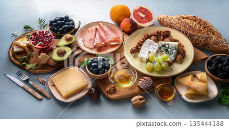 cheese plate with honey and grapes 135444188