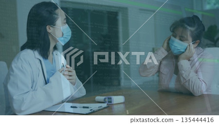 Masked doctor and patient consulting in office, with wooden table clipboard pen device 135444416