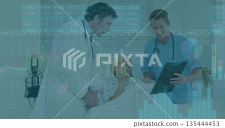 Reviewing patient vitals doctor and nurse leaning over hospital bed with stethoscopes and charts 135444453