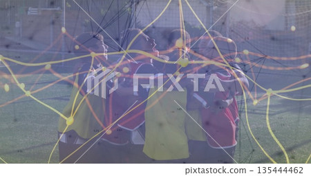 Huddling nine boys wearing colorful training bibs on soccer turf with network graph overlay Huddling nine boys wearing colorful training bibs on soccer turf with network graph overlay 135444462