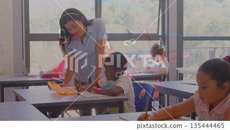 Leaning female teacher offering one-on-one assistance in classroom, with headphones and notebooks Leaning female teacher offering one-on-one assistance in classroom, with headphones and notebooks 135444465