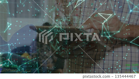 Mid adult man holding tablet computer and exploring holographic network in tech lab, with circuits Mid adult man holding tablet computer and exploring holographic network in tech lab, with circuits 135444467