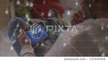 Reclining male wearing jeans holding smartphone viewing financial charts on couch in living room 135444468