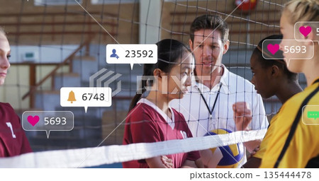 Directing coach guiding players in team jerseys at school gym, with net clipboard social icons 135444478