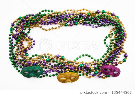 Mardi gras party beads creating frame with masks 135444502