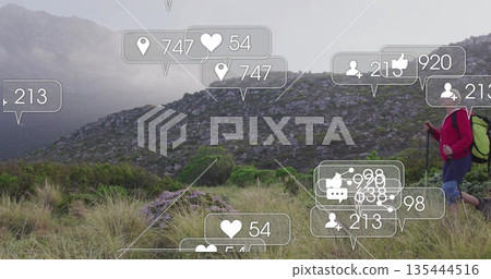 Traversing solo hiker in red jacket navigating misty hillside with social media icons, copy space Traversing solo hiker in red jacket navigating misty hillside with social media icons, copy space 135444516