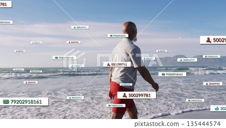 Strolling man wearing white polo shirt and red shorts along beach, with floating data labels Strolling man wearing white polo shirt and red shorts along beach, with floating data labels 135444574