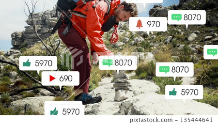 Hiker in red coat placing stone on rocky hill, with backpack rope alerts, copy space Hiker in red coat placing stone on rocky hill, with backpack rope alerts, copy space 135444641