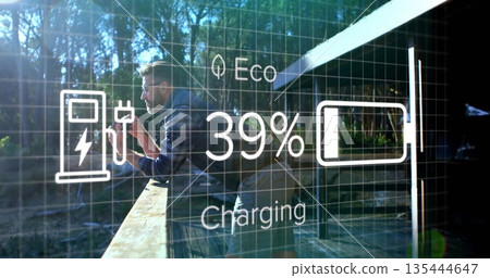 Examining male wearing plaid shirt kneeling on deck, holding smartphone with eco charging overlay 135444647