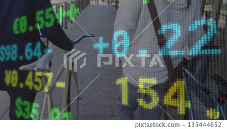 Walking friends pushing bicycles along riverside promenade, showing brown bag and financial data 135444652