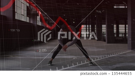Stretching athlete in hooded sweatshirt and leggings in industrial hall, with digital chart overlay Stretching athlete in hooded sweatshirt and leggings in industrial hall, with digital chart overlay 135444655
