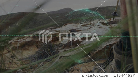 Projecting holographic overlay on hillside outcrop, near hiking boot and trekking pole, copy space Projecting holographic overlay on hillside outcrop, near hiking boot and trekking pole, copy space 135444657