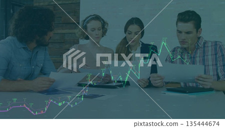 Colleagues analyzing stock market data on charts in office, with tablet and folder Colleagues analyzing stock market data on charts in office, with tablet and folder 135444674