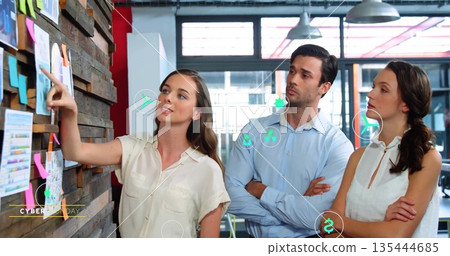 Pointing woman in blouse explaining plan at wood accent wall, with sticky notes, charts, copy space Pointing woman in blouse explaining plan at wood accent wall, with sticky notes, charts, copy space 135444685