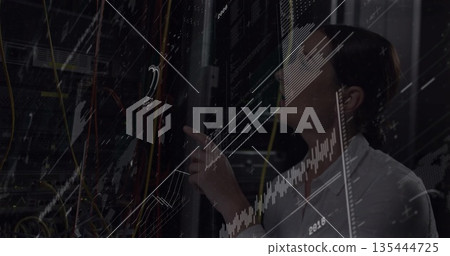 IT technician inspecting server rack in server room, with patch cables, digital graphs, copy space 135444725
