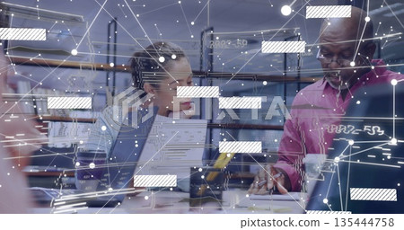 Collaborating group of four professionals analyzing data with laptops at office, with AR overlay Collaborating group of four professionals analyzing data with laptops at office, with AR overlay 135444758