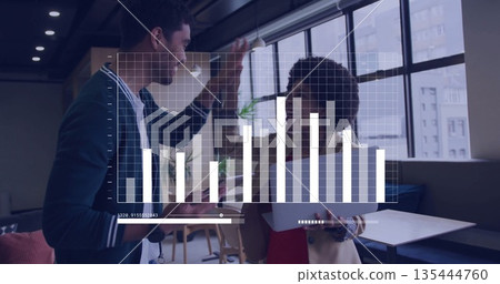 High-fiving two business professionals in office lounge, with tablet and digital bar chart overlay High-fiving two business professionals in office lounge, with tablet and digital bar chart overlay 135444760