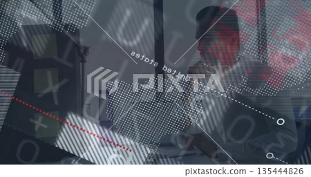 Man analyzing data overlays in office space, with laptop, monitor, coffee mug, notebook, copy space 135444826