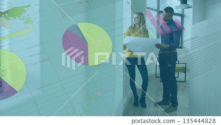 Woman in mustard sweater and man in blue shirt reviewing blueprint in office corridor, copy space 135444828