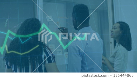 Discussing team of three wearing suits marking glass wall in office with sticky notes chart overlay 135444863